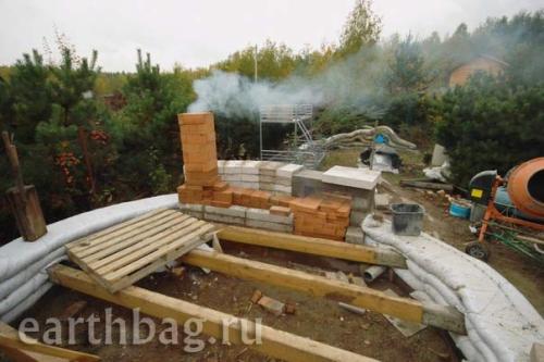 Earthbag house with mass heater fireplace at Earthbag.ru
